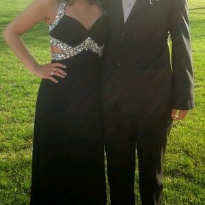 Long black open back dress with jewels.